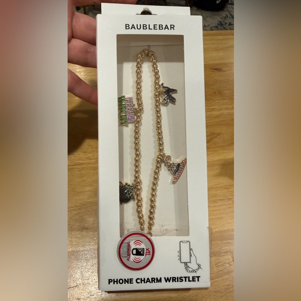 BaubleBar Phone Charm Wristlet features gold beads and Halloween-themed charms